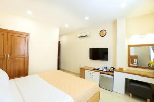 a hotel room with a bed and a mirror at Mia Hotel in Ho Chi Minh City