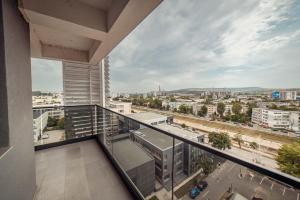 a balcony with a view of a city at Amazing Cozy and Lovely Studios and Apartments Q Residence Iasi in Iaşi