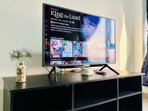 a large screen tv sitting on top of a table at Eco Kanvas Soho Suites in Cyberjaya