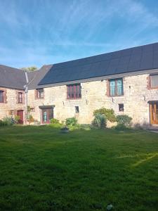 a house with solar panels on the side of it at LA VALLEE MARIAUX in Bossus-lès-Rumigny