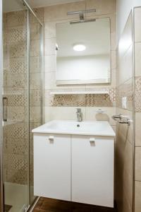 a bathroom with a white sink and a shower at Residence Elle in San Benedetto del Tronto +120 photos