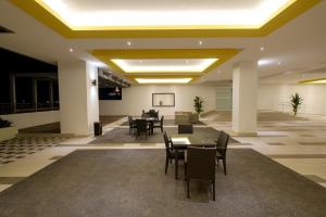 a dining room with tables and chairs in a building at Ipoh Majestic Suites 3R2B by Migliore in Ipoh