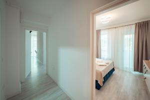 a bedroom with a bed and a large mirror at LUXURY Cozy Apartments and Studios Palas Mall Iasi in Iaşi