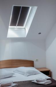 スンバタ・デ・ススにあるPensiunea Victoria Sambata de Susのベッドルーム1室(ベッド1台、上部に窓付)