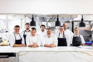 a group of chefs standing in a kitchen at La Bastide Bourrelly - Mathias Dandine in Cabriès