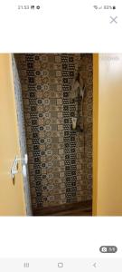 y baño con ducha y pared de azulejos. en Chambre d hotes le pigeonnier en Fromelles