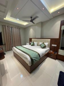 a bedroom with a bed and a ceiling fan at Vishwanath Inn in Varanasi