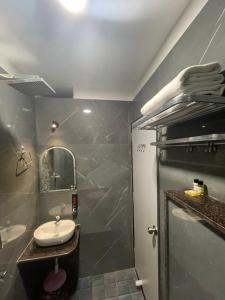 a bathroom with a sink and a mirror and a shower at Vishwanath Inn in Varanasi