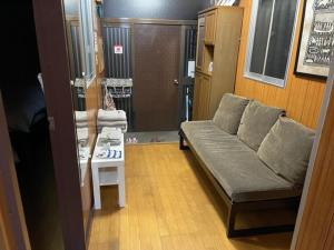 a living room with a couch and a table at Family Resort Apartment in Funabashi