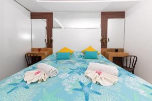 a bedroom with a blue bed with towels on it at Lemon House, Capri in Capri