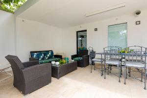 a living room with a couch and a table and chairs at Lemon House, Capri in Capri