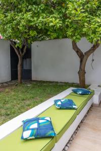 two blue pillows sitting on a green table with trees at Lemon House, Capri in Capri +5 photos