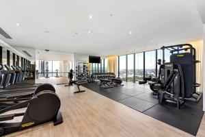 a gym with treadmills and machines in a building at Above Broadbeach casino 1BRplus Study ocean-city views in Gold Coast