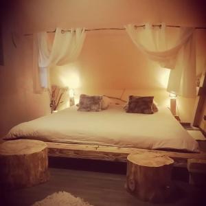 a bedroom with a bed with two pillows on it at Lodge bien être et nature in Soultzeren