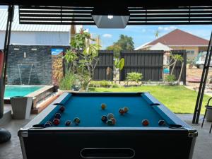 a pool table with balls on it in a yard at The Nack Resort & Pool Villa บางบัวทอง in Nonthaburi