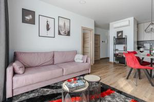 a living room with a couch and a table at Home sweet Home in Vilnius