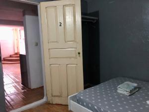 a bedroom with a door with a bed in it at Casa de Ferias in São Tomé