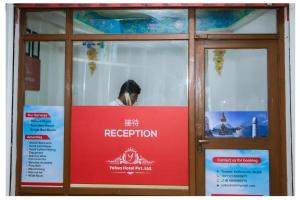 szklane drzwi z czerwonym napisem w obiekcie Yaksa Hotel Pvt. Ltd. w Katmandu