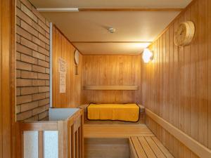 una pequeña sauna con una cama amarilla. en Kur Park Nagayu en Nitta