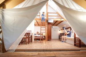 a group of people in a room with a tent at Garden Village Bled in Bled