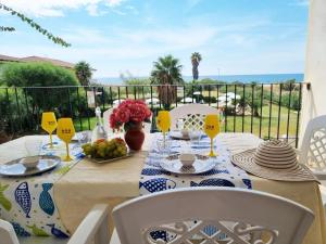 a table with a plate of food and a view of the ocean at Barko Apartments & Suites in Steccato