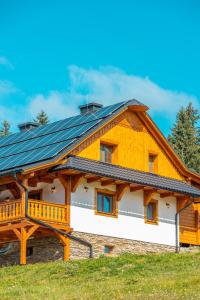 a house with solar panels on the roof at Wellness Chalupa Benešky in Vsetín