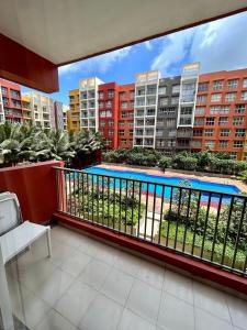 a balcony with a swimming pool and some buildings at Good Stay Premium Studio Apartment 206 in Dabolim