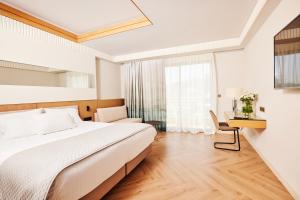 A bed or beds in a room at Mediterranean Hotel
