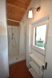 a bathroom with a shower and a window at Complesso La Foce - Clima, parcheggi, spazi esterni privati in Marina di Campo +190 photos