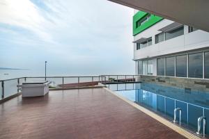 a balcony of a building with a swimming pool at Whiz Prime Hotel Megamas Manado in Manado