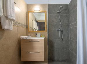 a bathroom with a shower and a sink at Apollo Resort in Agia Marina Aegina