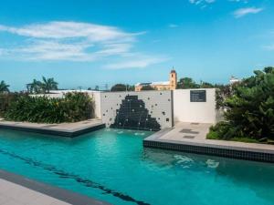 a swimming pool with blue water and a fountain at Modern Dual Key Apt w Pool in the heart of Mackay in Mackay