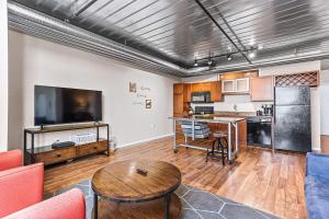 a living room with a couch and a table at Spacious 2 King Bed Downtown Central to it All in Ann Arbor