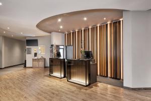 a large room with a kitchen and a living room at Sunday Hotel Köln Hürth in Hürth