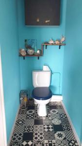 uma casa de banho com um WC numa parede azul em chambre sur Muret em Muret