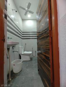 a bathroom with a toilet and a sink at Hotel Yolo in Chandīgarh