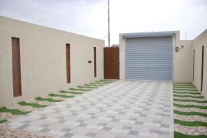 a house with a garage and a checkered driveway at Luxury residences in Khamis Mushayt
