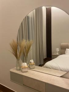 a bedroom with a large mirror and a bed at Luxury residences in Khamis Mushayt