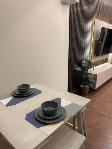 two black bowls on a table in a room at Luxury residences in Khamis Mushayt