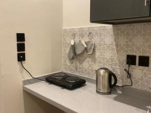 a kitchen counter with a tea kettle on a counter top at Luxury residences in Khamis Mushayt