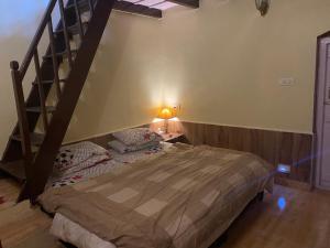 a bedroom with a bed and a spiral staircase at Kanjira house in Ooty