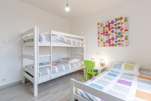 a bedroom with two bunk beds and a desk at Villa Yana Bretagne Piscine Intérieure partagée et Spa Privatif 100m de la Plage in Sibiril +40 photos