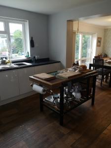 a kitchen with a wooden table in a room at Cedar Top in Manston