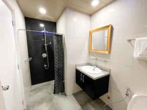 a bathroom with a shower and a sink at Kandi Palace Hotel D20 in Angeles