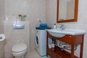 a bathroom with a sink and a washing machine at Casa Laguna in Costa Calma