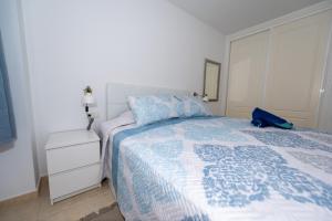 una camera con un letto con una coperta blu e bianca di Casa Laguna a Costa Calma