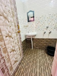 uma casa de banho com um lavatório e um chuveiro em Mangalam guest house em Puri