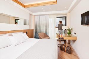 A bed or beds in a room at Mediterranean Hotel