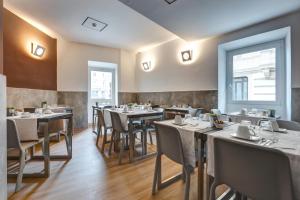 a restaurant with tables and chairs in a room at Rome Art Hotel - Gruppo Trevi Hotels in Rome