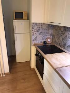 a kitchen with a white refrigerator and a microwave at Apartman Luka in Slavonski Brod